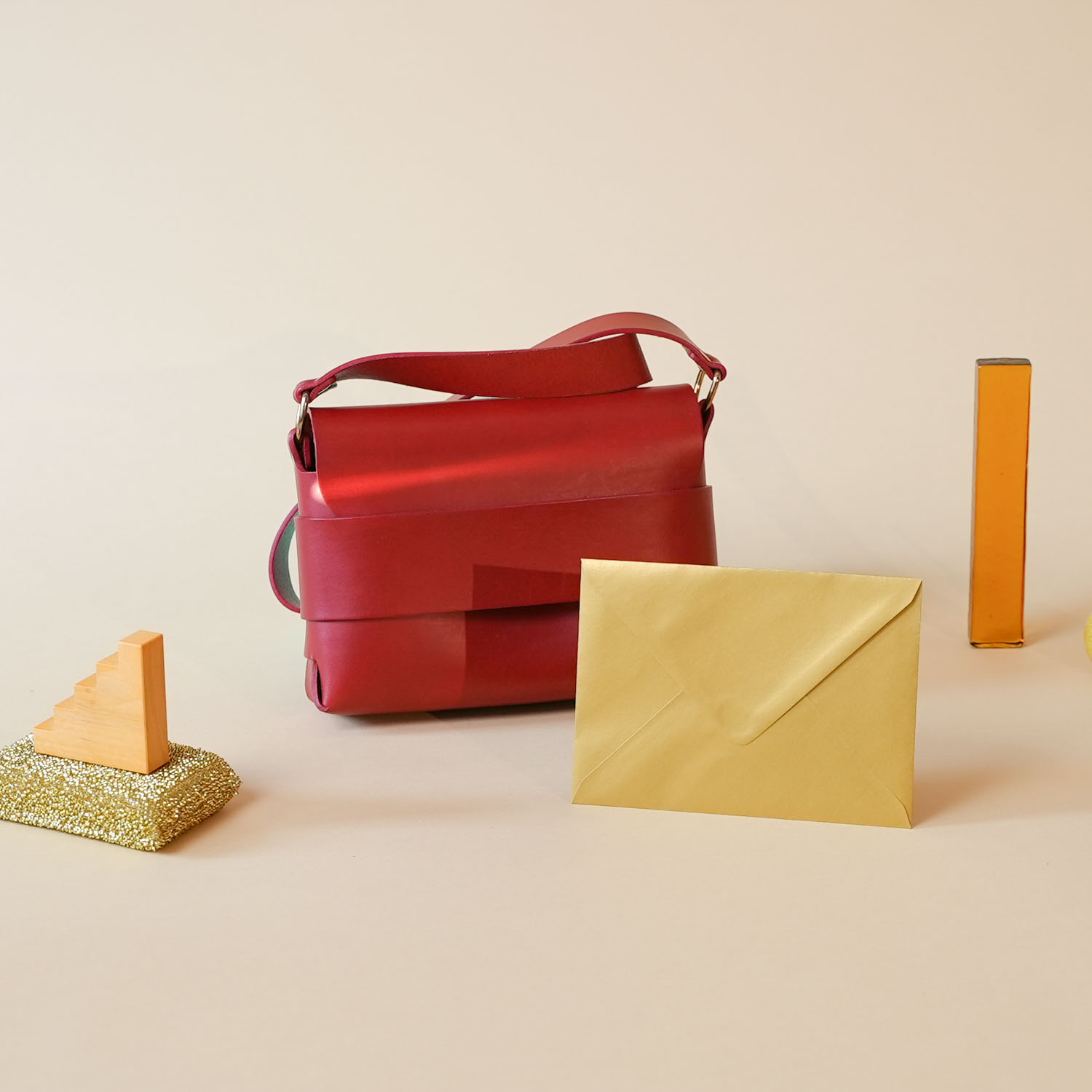 Bag with envelop on beige backdrop